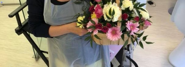 Katy Jobbins receiving flowers from permanent makeup student